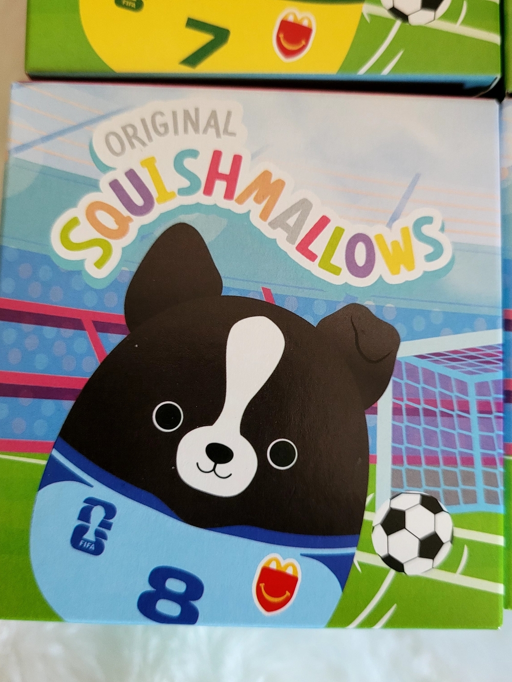 Squishmallows Black and White Soccer Pup in Blue Jersey